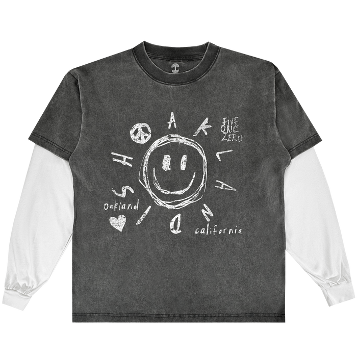 The Oaklandish Scribble LS Tee is a vintage black, 100% cotton long-sleeve shirt with white sleeves, featuring a large sketched smiley face and playful white doodles: “Oakland,” “California,” “Five One Zero,” peace sign, heart, arrows, letters.