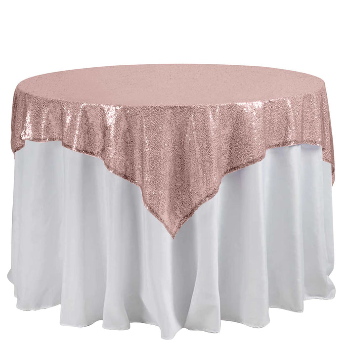 Rose gold sequin tablecloth draped over a round table.