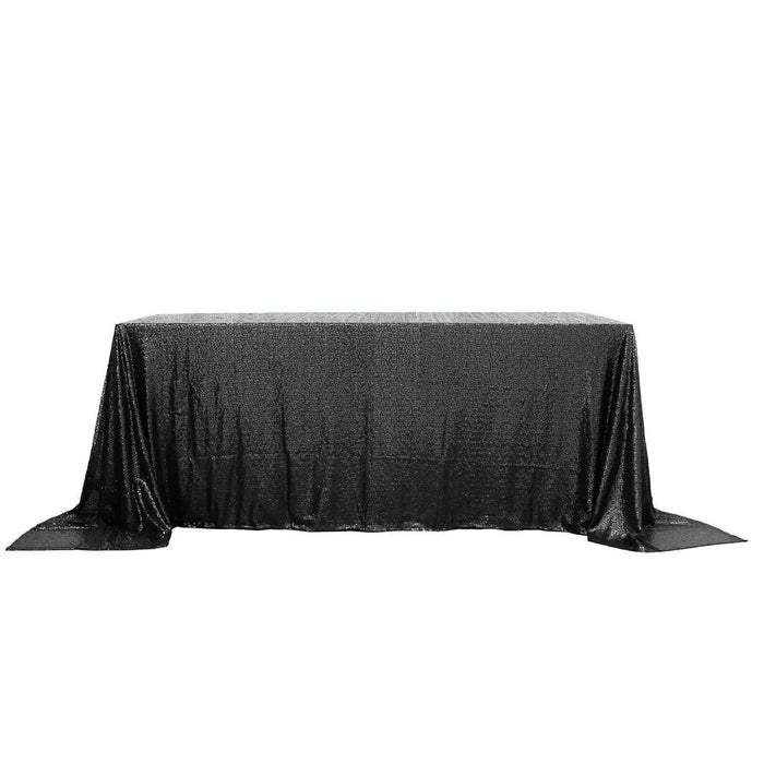 Black sequin tablecloth draping over a rectangular table