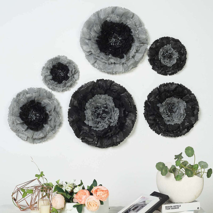 Black and gray decorative paper flowers on a wall with a modern vase and flowers