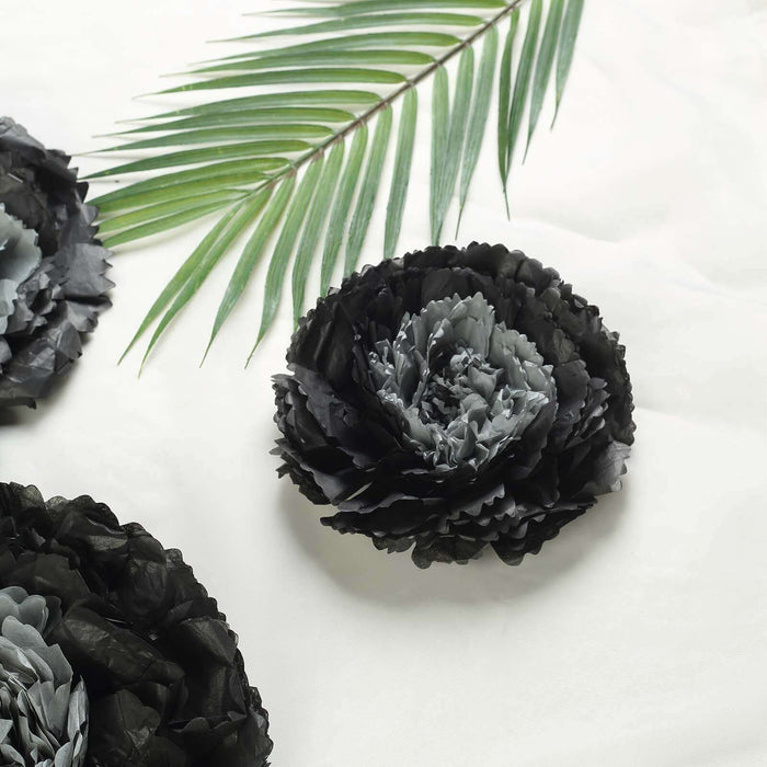 Black and gray decorative paper flowers with a palm leaf