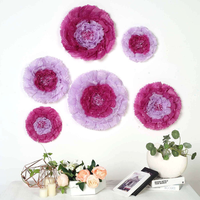 Colorful paper flowers arranged on a wall with decorative plants and books