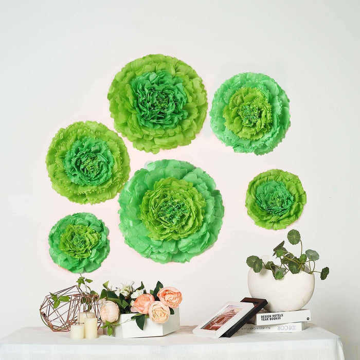 Green paper flower wall decor set on a table with vases and plants.