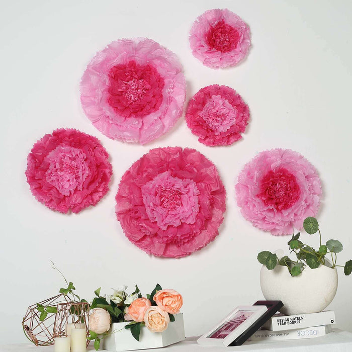 Pink decorative paper flowers arranged on a wall with a floral display.
