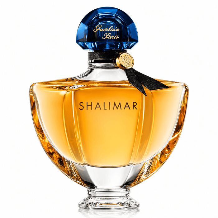 Guerlain Shalimar EDP amber glass perfume bottle with a sculpted base, black ribbon, and blue jewel-like cap