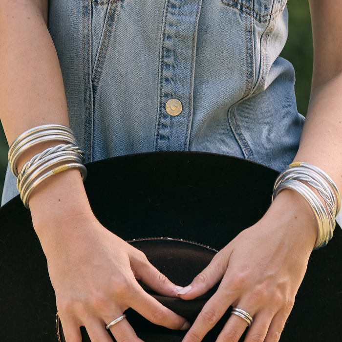 a person wearing a hat and bracelets
