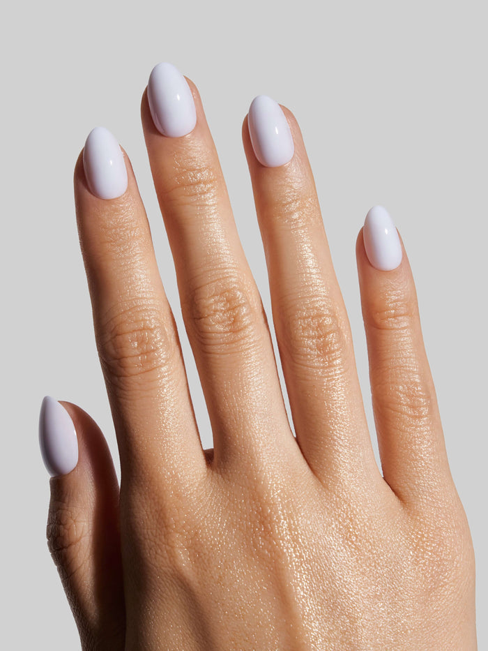 Hand with sky blue press-on nails on a neutral background