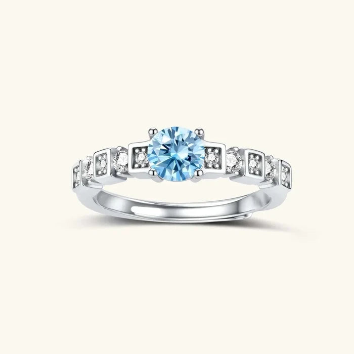 Skyline Light Blue Moissanite Ring with a round pale blue center stone and clear accents in geometric silver settings