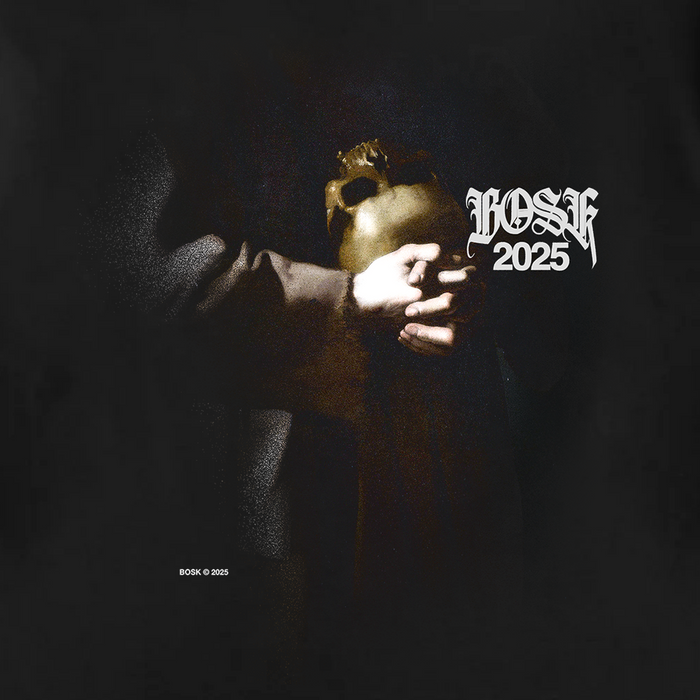 A dimly lit figure holds a golden theatrical mask in both hands. The upper torso and arms are visible, draped in the St. Francis Tee by Other—a classic fit black t-shirt crafted from heavy-weight cotton. “LOSK 2025” appears in ornate white text at the top right; “BOSK © 2025” is at the bottom left.