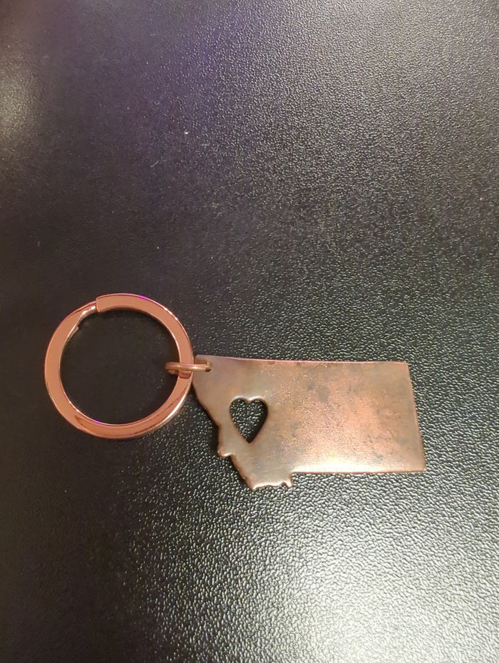 BadAssBabe State of MT keychain featuring a metal key chain with the Montana state outline and design details.