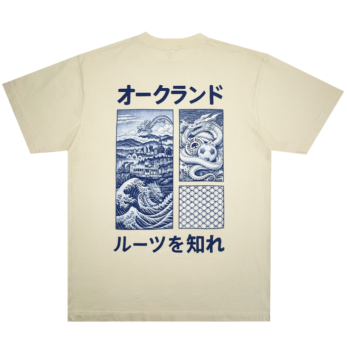 The Story Telling Tee by Oakland Roots SC is a beige t-shirt featuring blue Japanese text and four panels—a dragon over a city, serpent in water, ocean waves, and fish scales—plus more blue Japanese text for Roots SC fans.