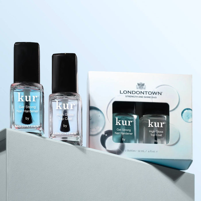 Two LONDONTOWN Strength & Shine Duo bottles and a matching boxed set are displayed against a light blue background, offering strong nails with a smooth, shiny finish.