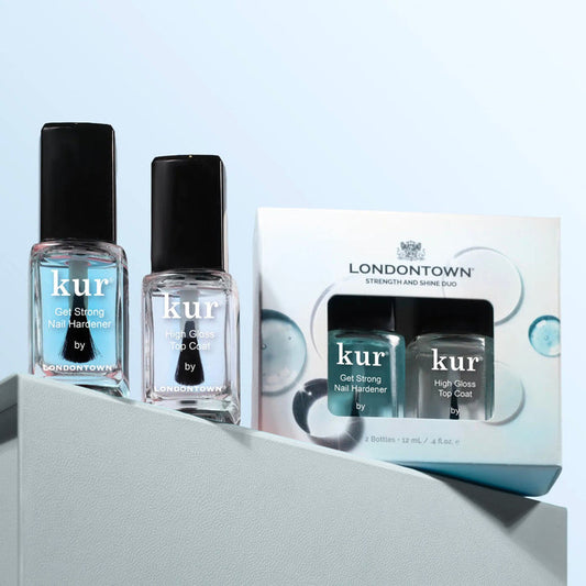 Two LONDONTOWN Strength & Shine Duo bottles and a matching boxed set are displayed against a light blue background, offering strong nails with a smooth, shiny finish.