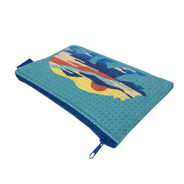 The Sunset Bear Pouch by Oaklandish is a rectangular, turquoise zip pouch that features a vibrant, abstract design on one side. Made from waffle weave fabric, it has a blue zipper extending to one side and is finished with a small blue pull tab. The striking design includes various shapes in blue, red, and beige hues.