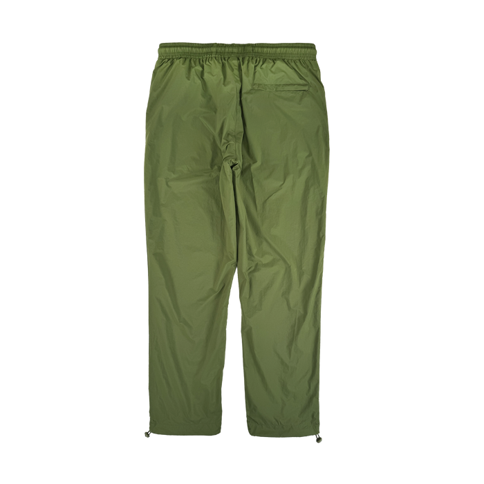 The Susurrus Track Bottom by Oaklandish features lightweight olive green nylon, an adjustable waistband, single right back pocket, and drawstring ankles. These relaxed, straight-leg pants are inspired by classic army style.