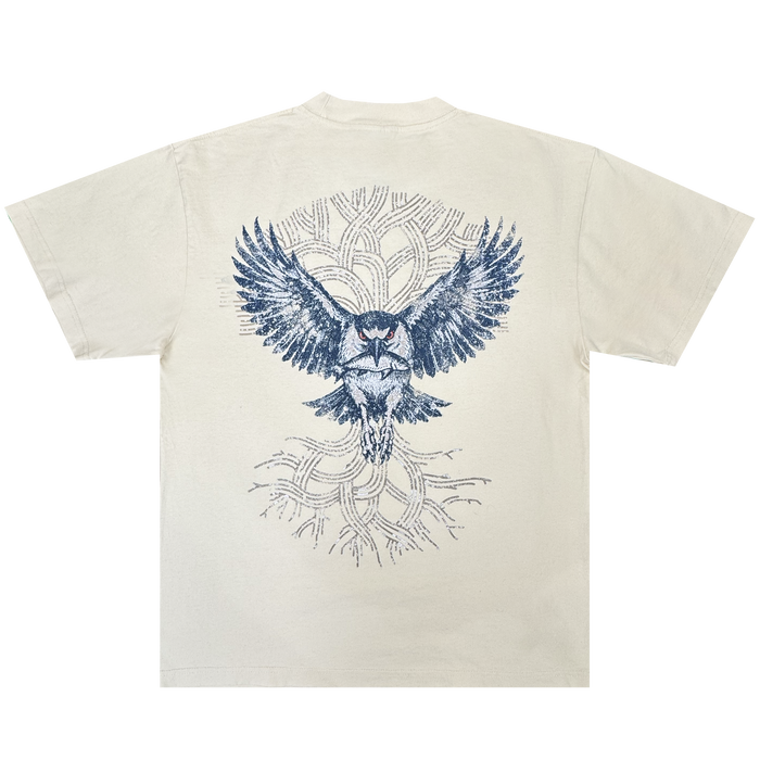 The Oaklandish Swoop Tee is a cream-colored, heavyweight cotton men’s t-shirt featuring a bold blue owl graphic with outstretched wings on the back. Abstract, tree-like branches form a circular pattern behind the owl, adding depth to the layered design on this classic fit tee.
