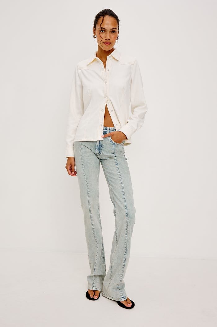 Taiana Shirt in Cotton Lyocell Denim With Collar Front and Back Darting Western Yoke Front Snap Buttons Long Sleeves and Fitted Silhouette in Ivory Colorway - Full Body Front View Featured on Model