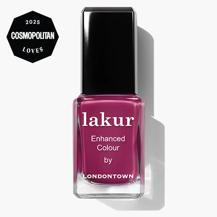 A bottle of LONDONTOWN Lakur Enhanced Colour nail polish in the pink “Teeny 'Kini” shade, featuring a “2025 Cosmopolitan Loves” badge in the top left corner.