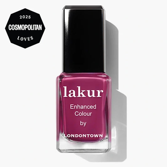 A bottle of LONDONTOWN Lakur Enhanced Colour nail polish in the pink “Teeny 'Kini” shade, featuring a “2025 Cosmopolitan Loves” badge in the top left corner.