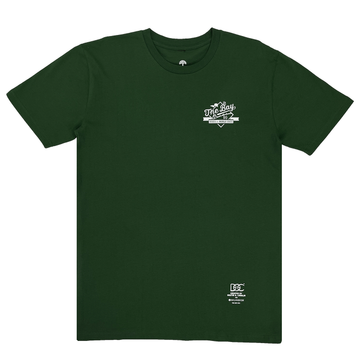 Frontside view of a green t-shirt white The Bay Makes The World Takes logo graphic on left chest wearside.