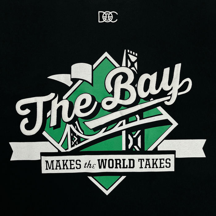 Featuring stylized script reading “The Bay” in bold lettering atop a green geometric design with bridge motifs, The Bay Tee by DOC from Other captures the vibrant spirit of Bay Area culture. Below, a crisp white ribbon bears the phrase “MAKES the WORLD TAKES,” while interlocking white letters sit above—an homage to The Bay Collection—all printed on a classic fit t-shirt.