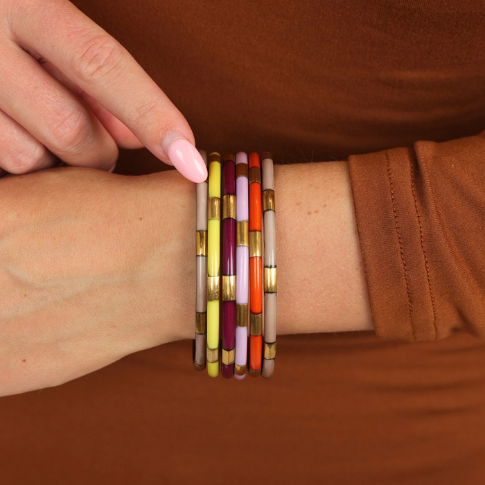 a person wearing bracelets on their wrist