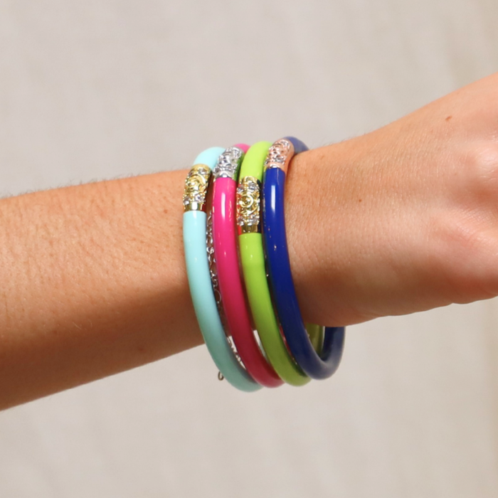 a hand with colorful bracelets