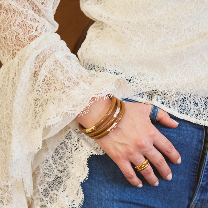 a close up of a hand with bracelets