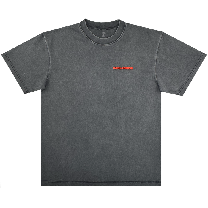 The Tiger Blood Tee by Oaklandish is a vintage black, 100% cotton short-sleeve shirt with a crew neck and clean stitching, featuring “OAKLANDISH” in small bold red letters on the left chest and no other graphics.