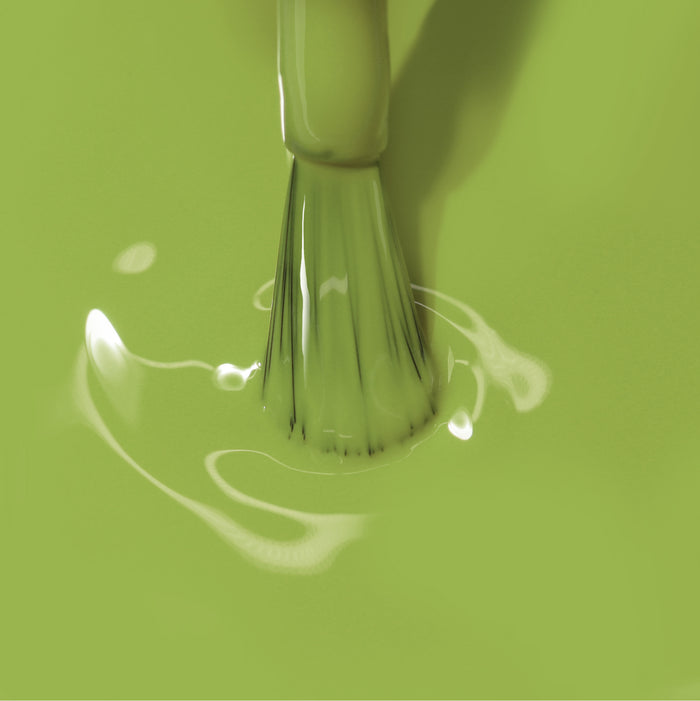 Close-up of a paintbrush dipped in LONDONTOWN's Tipsy Mermaid paint.