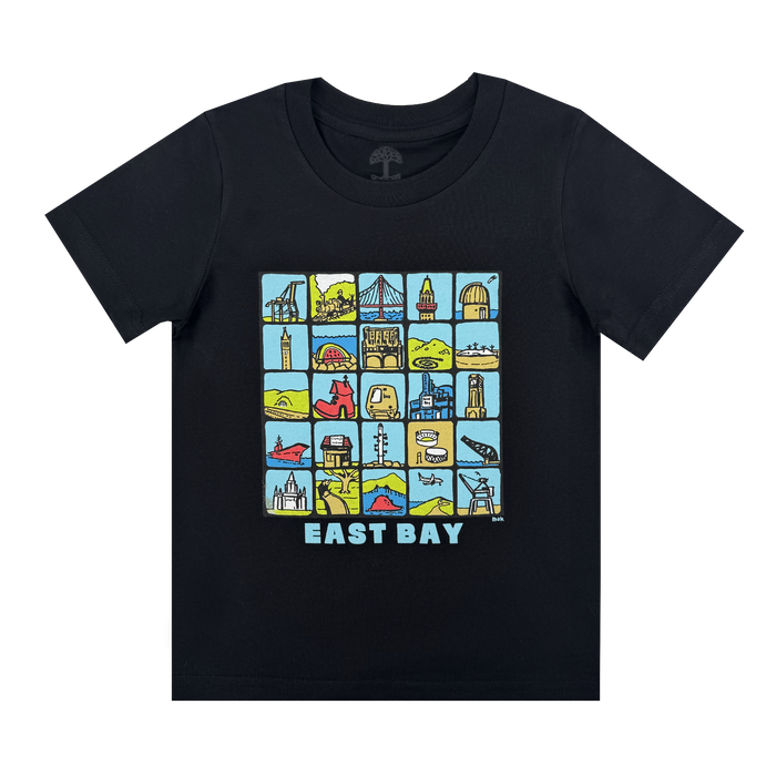 The Oaklandish Toddler East Bay Landmark Tee is a black shirt with a colorful grid of East Bay sites—buildings, bridges, hills, and boats—and “EAST BAY” in bold letters below black-outlined illustrations on a light blue background.
