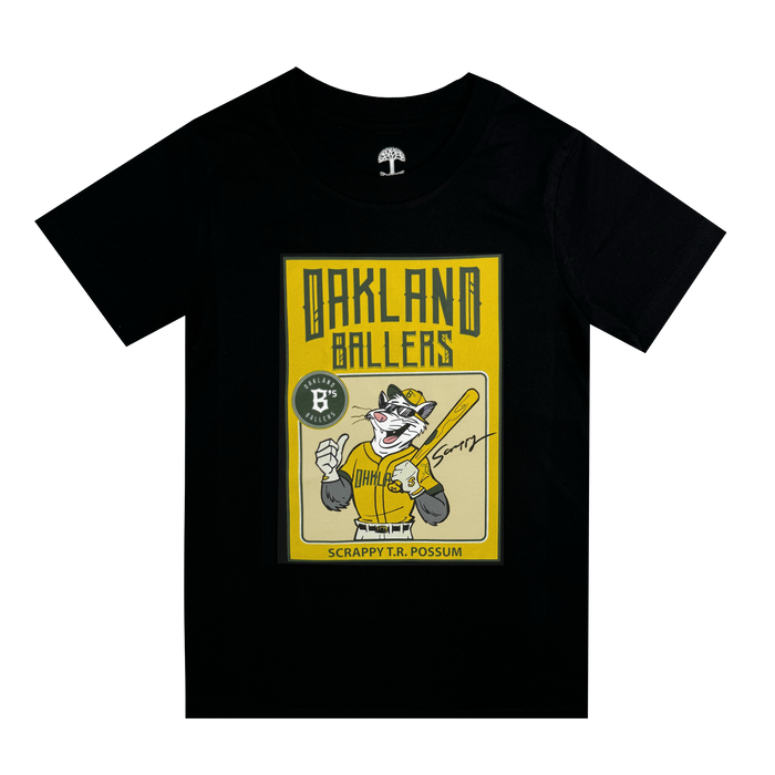 The Toddler Scrappy Rookie Tee by Oakland Ballers is a black T-shirt with a vintage-style baseball card graphic of mascot Scrappy the Rally Possum in a yellow jersey, holding a bat. The card reads “OAKLAND BALLERS” and “SCRAPPY T.R. POSSUM” with a “Sorry!” signature.