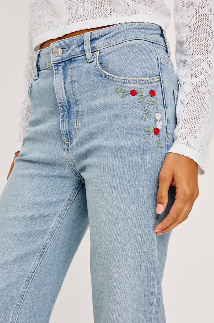 Topanga High-Rise Wide Straight Leg Jean in With 5-Pockets and a Front Zip-Fly in Dainty Rose Colorway - Lower Body Side Close Up View Featured on Model