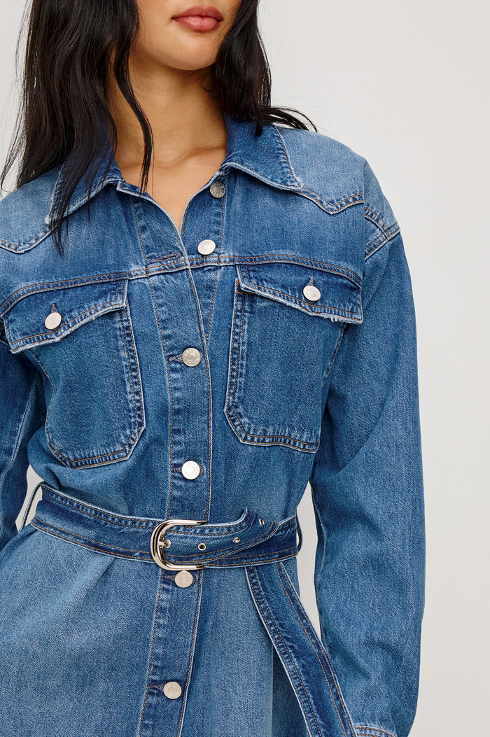 Tustin Mini Shirt Dress in Rigid Denim With Western Yoke, Front Buttons, Self Belt, Dropped Shoulders, and Long Sleeves in Skyride Colorway - Lower Body Front View Featured on Model