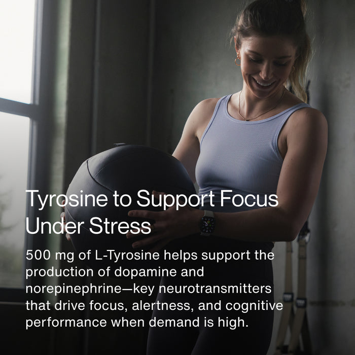 Athletic woman holding a medicine ball in a gym setting. Text reads: “Tyrosine to Support Focus Under Stress. 500 mg of L-Tyrosine helps support the production of dopamine and norepinephrine—key neurotransmitters that drive focus, alertness, and cognitive performance when demand is high.”