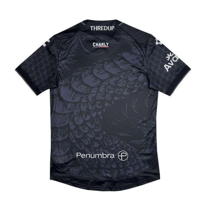 The Unisex Oak-ness Awakens Kit by Oakland Roots SC is a dark gray soccer jersey featuring a subtle scaled pattern inspired by the Oak-ness Monster, with bold white "Penumbra," "THREDUP," "CHARLY," and "AVOF" logos on the chest, shoulders, and front.