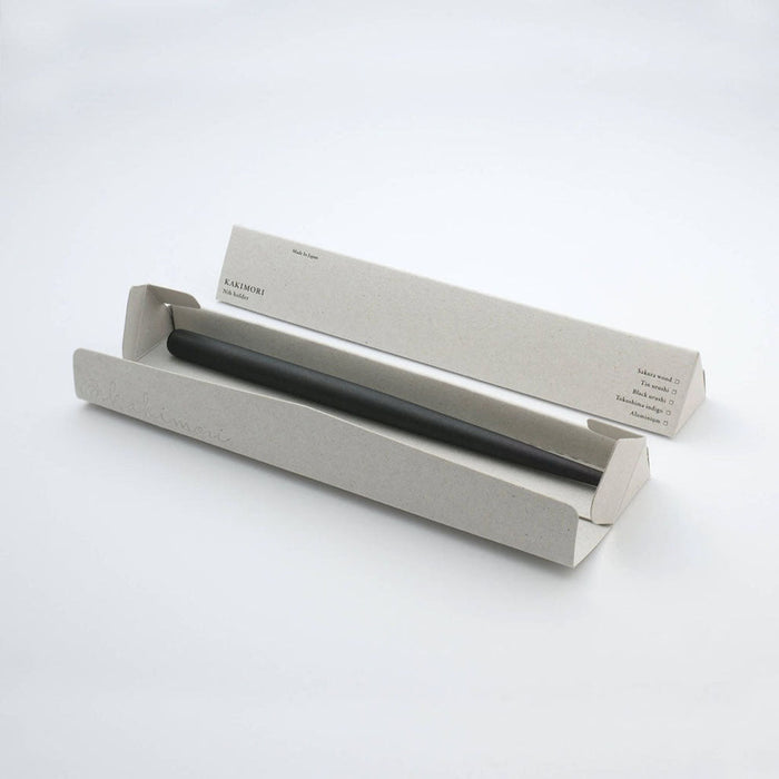 Black nib holder in gray box with Kakimori branding on white surface