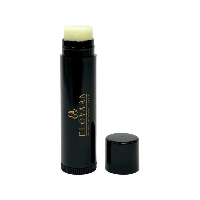 Vegan Lip Balm in a black cylindrical tube with gold lettering and pale cream balm exposed at the top