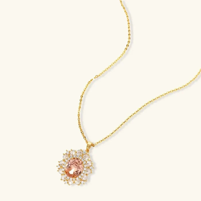 Vintage Glamour necklace and stud earring set with a gold-tone chain and peach oval pendant framed by clear stones