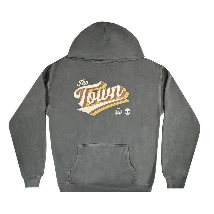 Introducing the Vintage Swash Hoodie by Other, a faded black pullover with a hood and front pocket from the exclusive Town Collection. The back showcases “The Town” in bold retro script accented by gold and cream swooshes, along with two small circular logos beneath—a tribute to the distinct Warriors x Oaklandish collaboration. This hoodie features a vintage, worn-in look for added style.