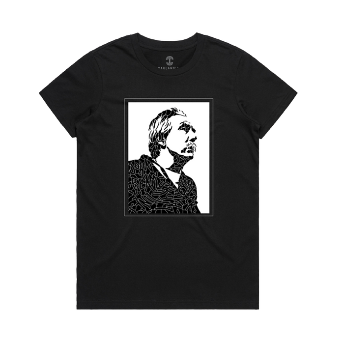 The Women's Coach Beam's Legacy Tee by Oaklandish is a black crew-neck shirt with a high-contrast graphic of an upward-looking figure, inspired by Coach John Beam and Oakland youth, framed in abstract lines on the chest.