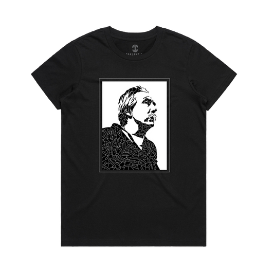 The Women's Coach Beam's Legacy Tee by Oaklandish is a black crew-neck shirt with a high-contrast graphic of an upward-looking figure, inspired by Coach John Beam and Oakland youth, framed in abstract lines on the chest.