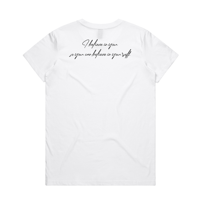The Women's Coach Beam's Legacy Tee by Oaklandish is a plain white short-sleeve shirt with "I believe in you so you can believe in yourself." in black cursive on the back, inspired by Coach John Beam’s dedication to Oakland youth. Shown on a solid white background.