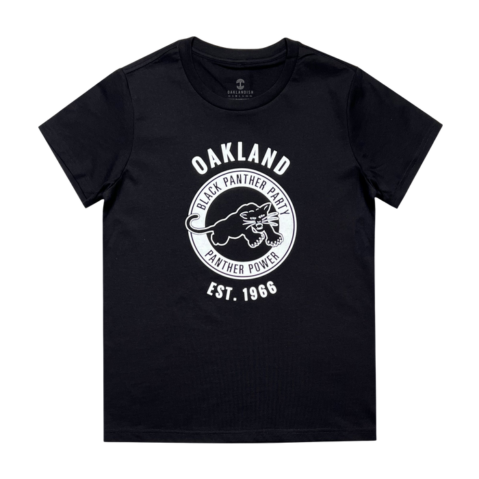 A black Women's Black Panther Power Tee from Oaklandish featuring a circular emblem with a panther illustration in the center. White text above and around the emblem reads "OAKLAND BLACK PANTHER PARTY PANTHER POWER," and additional text below reads "EST. 1966." Celebrating community organizations, the brand label "GALLANTHAWK" is inside the neckline.