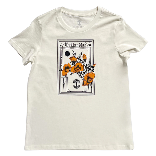 Made from soft cotton, the Women's Blossom Tee by Oaklandish presents an artistic design with bright orange poppies. It features a black abstract sun and geometric shapes, with the word "Outlandish" elegantly arched above the scene.