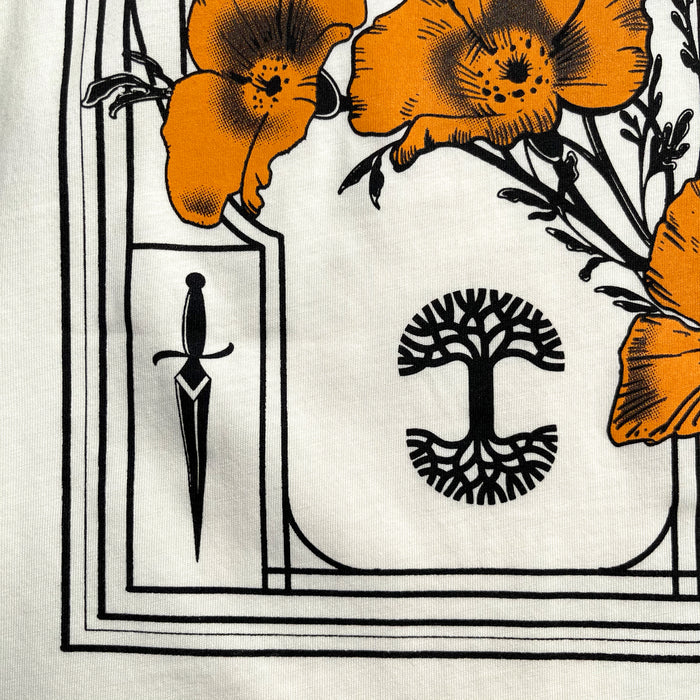 The Women's Blossom Tee by Oaklandish features a graphic design on a 100% cotton t-shirt, showcasing bright orange poppies with black accents on a white background. The flowers are encased in an ornate frame formed by thin black lines. A small dagger is positioned to the left, while the center displays a stylized tree-like symbol with symmetrical branches and roots.