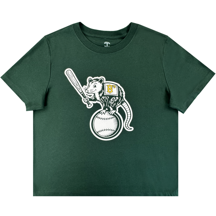 The Women's Clutch Tee from Oakland Ballers is a dark green shirt with a cartoon opossum holding a bat atop a baseball, wearing a "BP" patch—centered on the chest and ideal for Pioneer League and Oakland Ballers fans.
