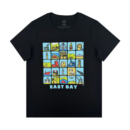 The Oaklandish Women's East Bay Landmarks Tee is a black shirt with colorful cartoon-style icons of bridges, buildings, and hills in a 5x4 grid above bold blue and white “EAST BAY” text.