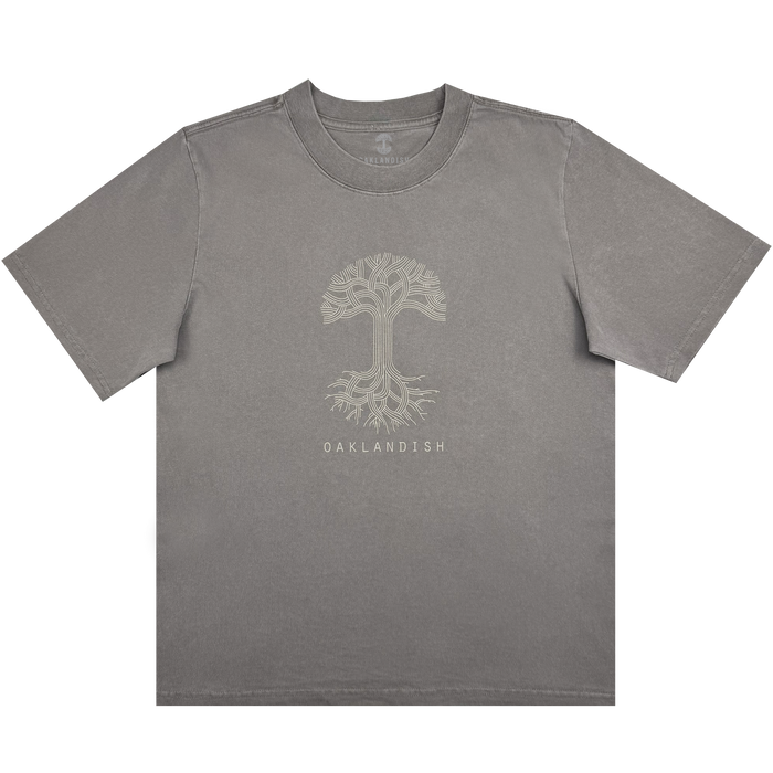 The Women's Oaklandish Classic Logo Heavy Tee by Oaklandish features an oversized fit in faded grey, showcasing a striking light beige tree design with intricate branches and roots. Crafted from heavy-weight 100% cotton, it includes "OAKLANDISH" text beneath the tree, a crew neck, and short sleeves for comfort.