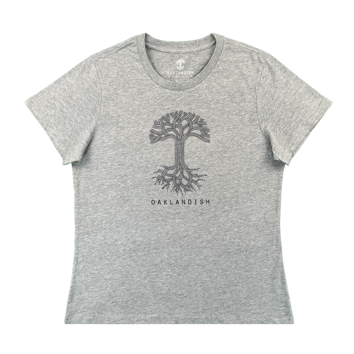 The Women's Oaklandish Logo Tee by Oaklandish is a classic fit, athletic grey shirt made from 100% cotton. It features a black line art tree with roots and “OAKLANDISH” in bold uppercase centered on the chest.